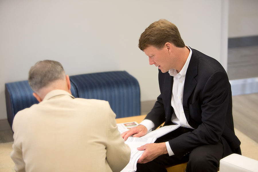 cl realty commercial real estate texas and beyond man working side by side on coffee table with customer client